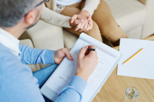 Psychologist talking to depressed woman in the office